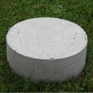precast concrete footing pad product in the grass